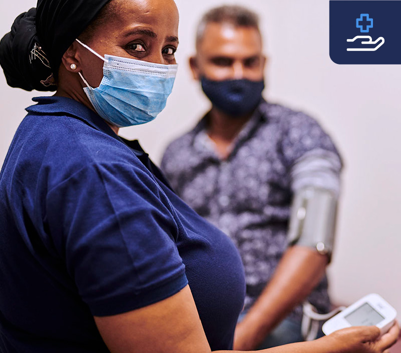 Nurse checking blood pressure of a patient using a Sphygmomanometer.