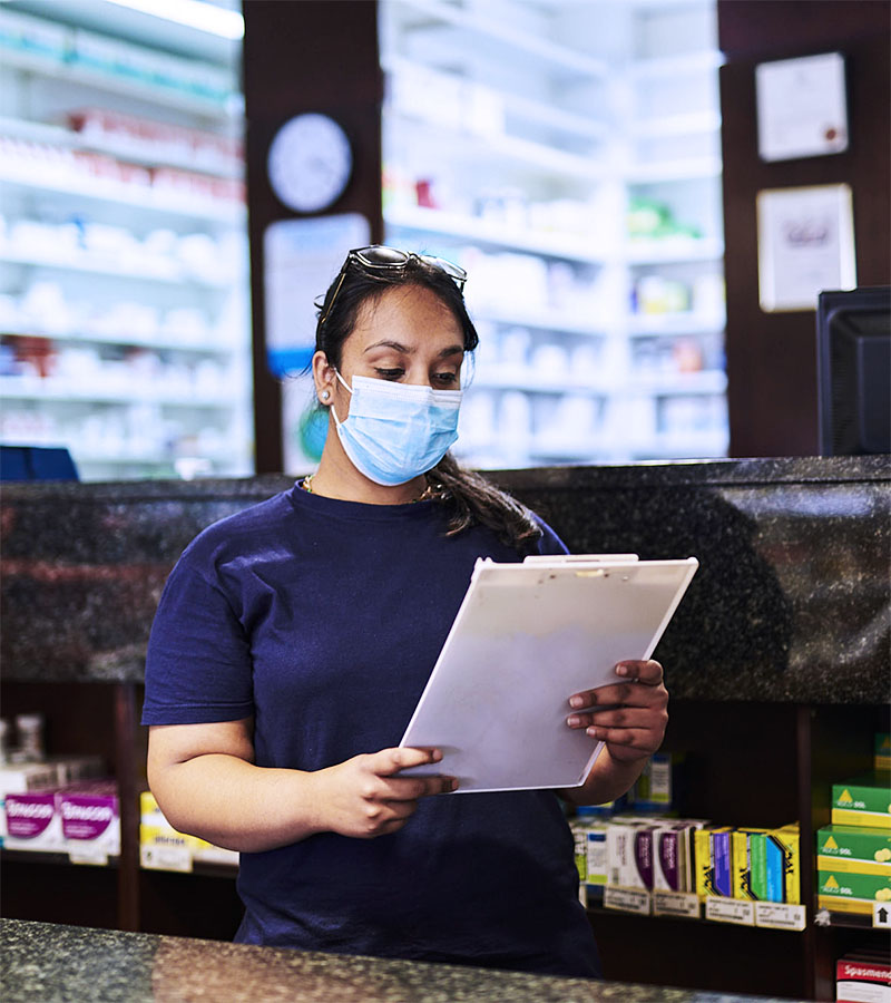 Pharmacist reading the cholesterol profile of a patient.